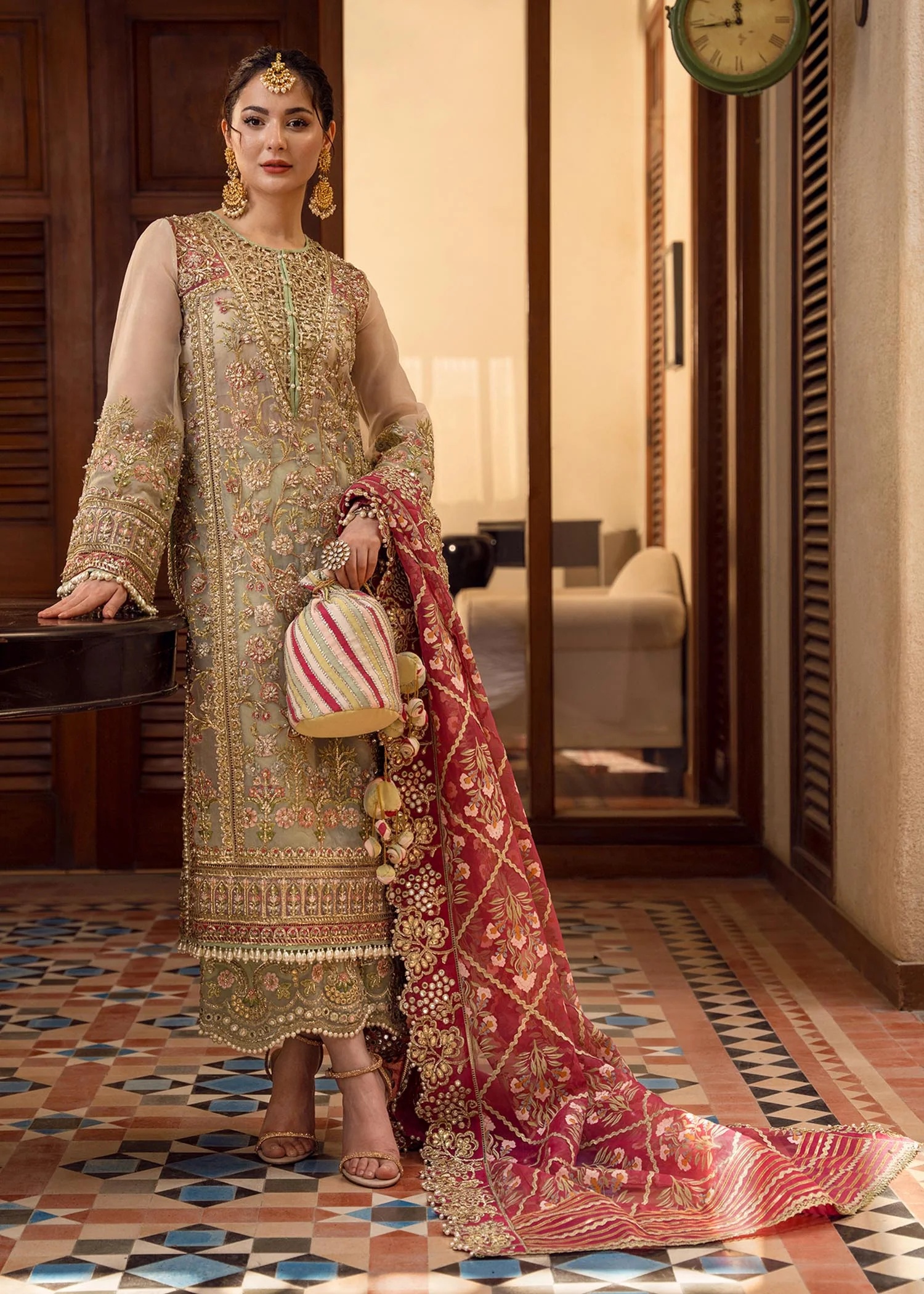 Artisanal Anecdotes Pakistani fashion outfit in gold, pink tones.